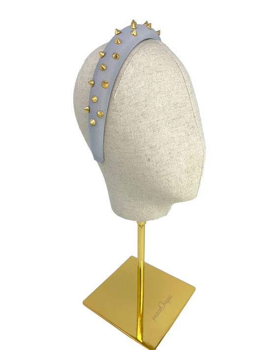 Grey padded headband with gold spikes